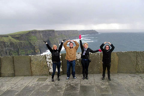 Maggie Dec and friends use their arms to spell out YOLO while studying abroad in Limerick, Ireland.