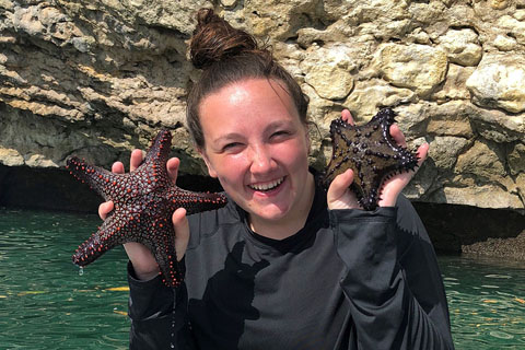 Jenna Keppel holds up two starfish in Costa Rica.