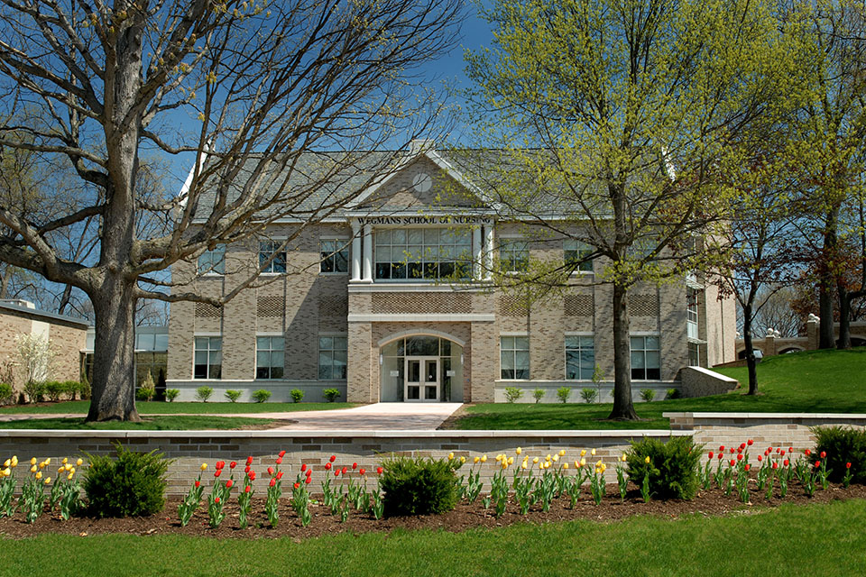 Exterior of the Wegmans School of Nursing in spring.